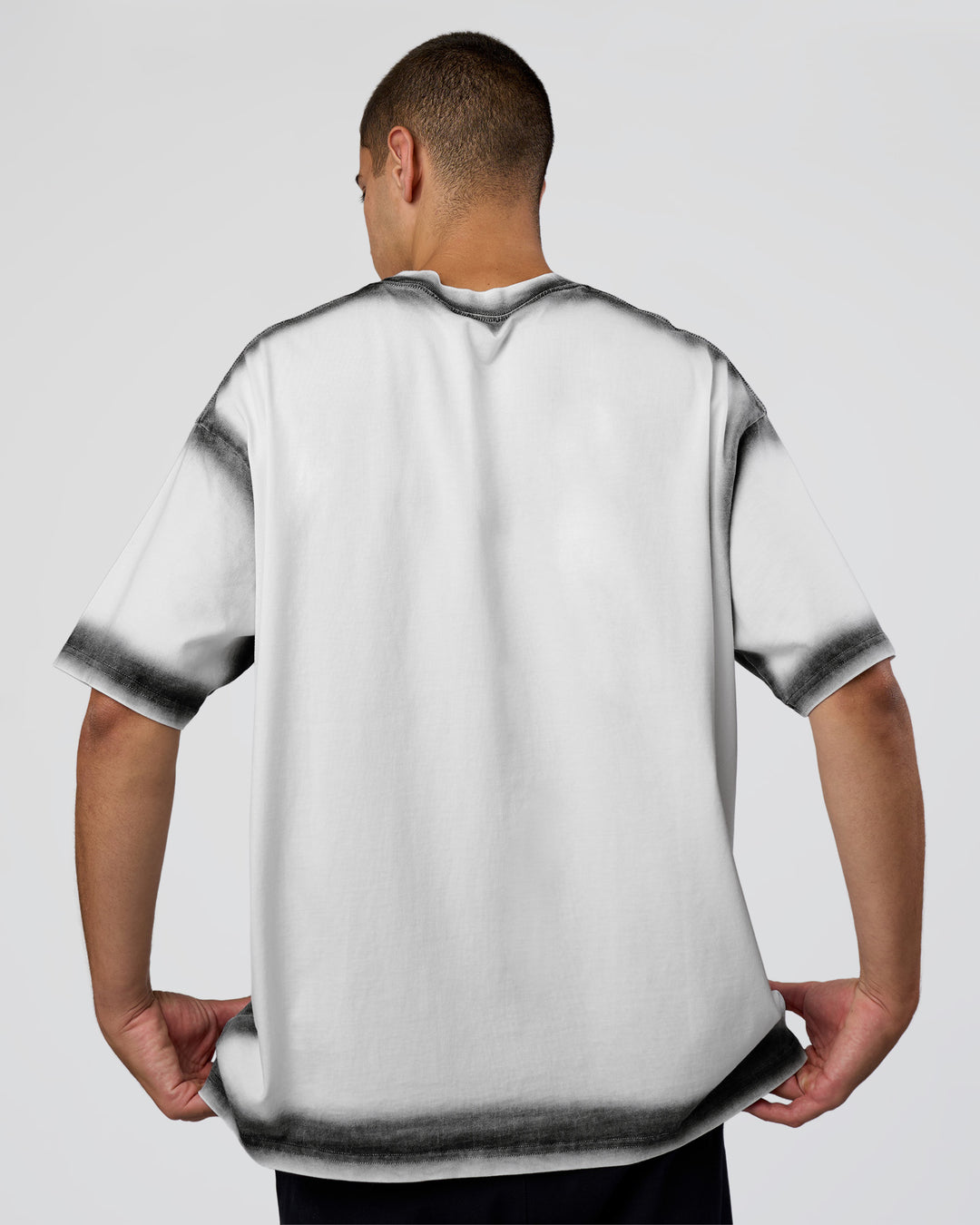 Man wearing Urban Blur Heavyweight Unisex Oversized Tee - White-Black | Model:Zoran | Size:M