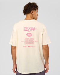 Man wearing Values Run Club FLXCotton Tee - Off White-Candy Pink | Model:Leandro | Size:M