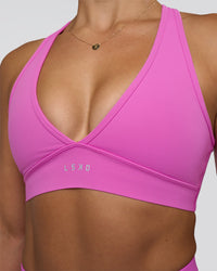 Woman wearing Stamina Sports Bra - Ultra Fuchsia | Set:true | Angle:closeup | Model:Abbey | Size:M