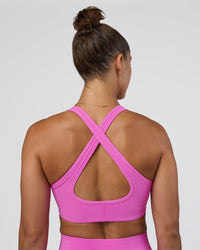 Woman wearing Stamina Sports Bra - Ultra Fuchsia | Set:true | Angle:back | Model:Abbey | Size:M