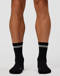 Man wearing Run Club Fast Performance Socks 2.0 - Black-Reflective | Thumbnail Index: 5