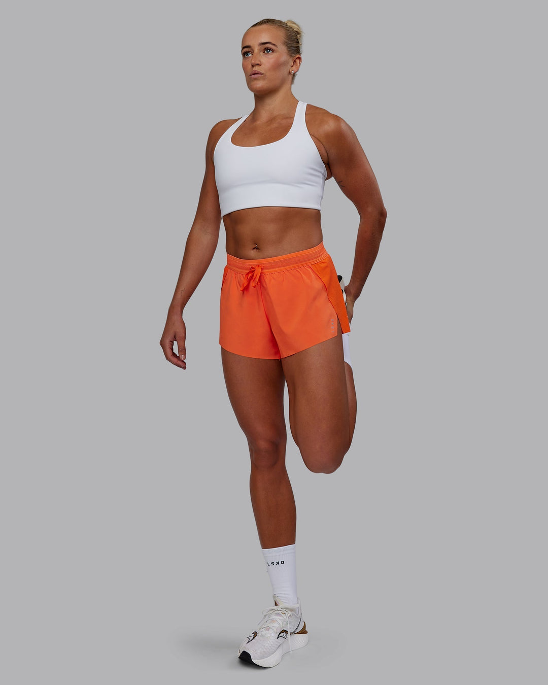 Woman wearing Accelerate Run Shorts - Ultra Orange