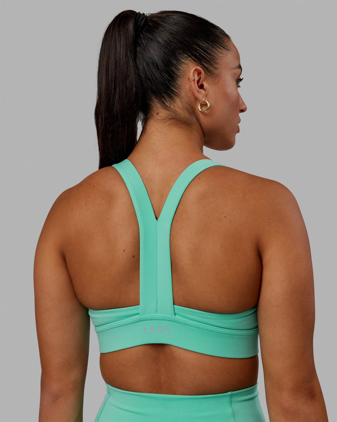 Woman wearing Advance Sports Bra - Aquatic Awe