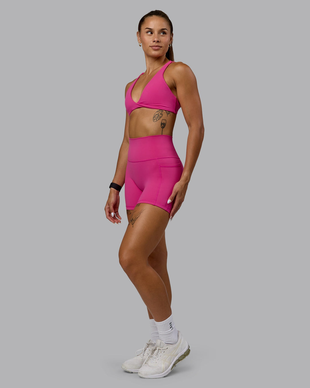 Woman wearing Agile Sports Bra - Fuchsia Pink