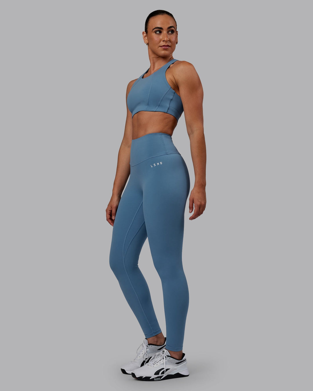 Woman wearing Ascent Sports Bra - Elemental Blue