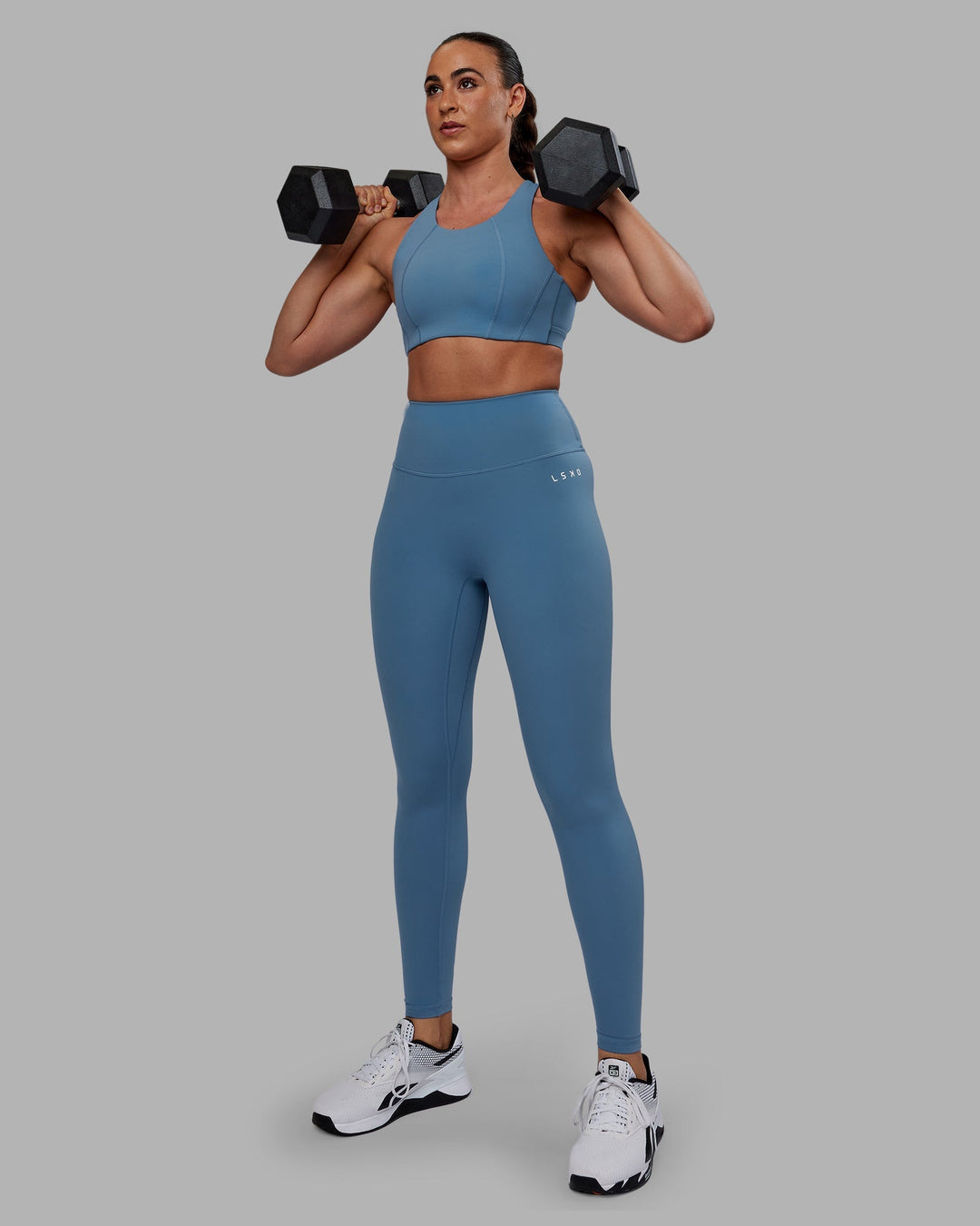 Woman wearing Ascent Sports Bra - Elemental Blue