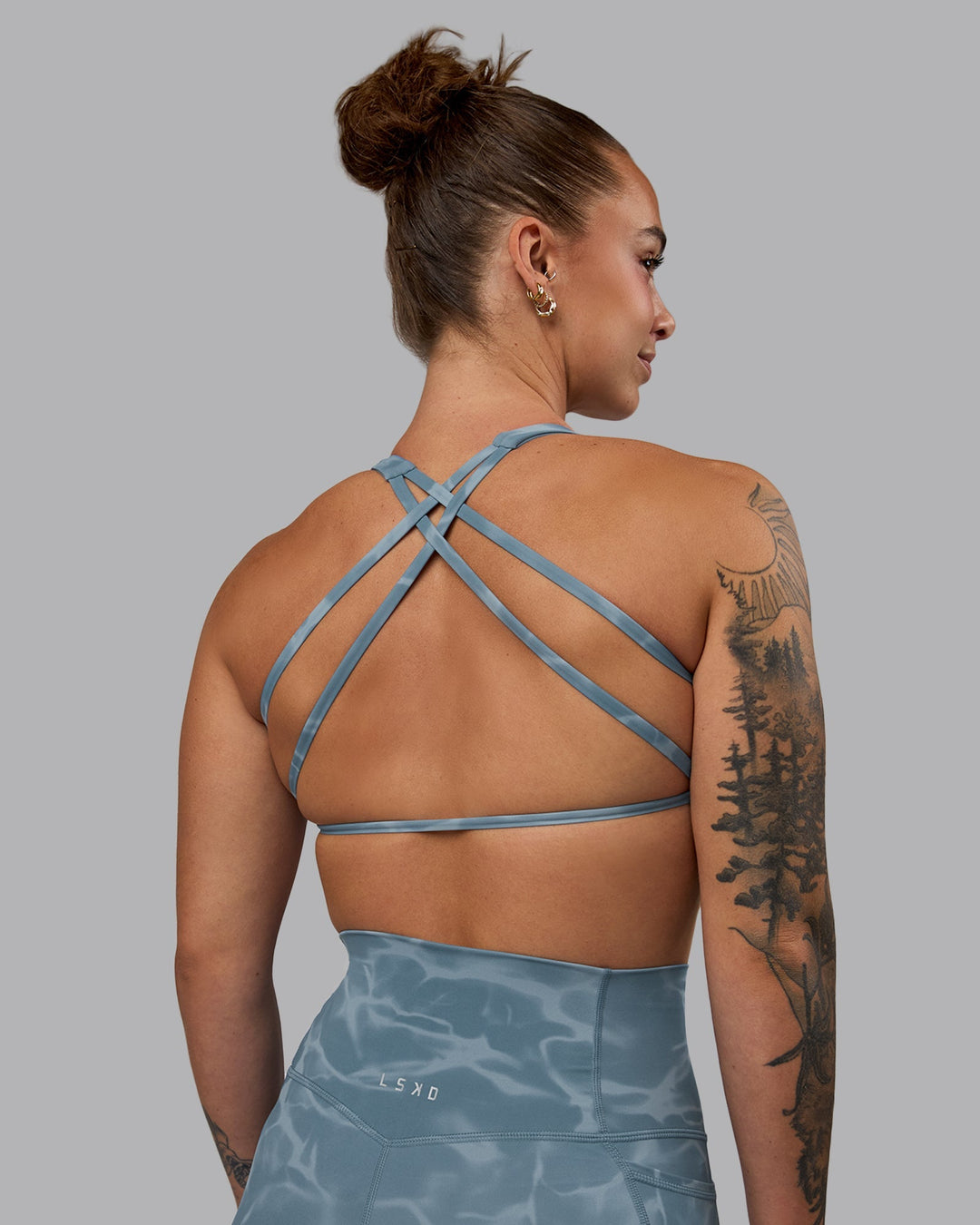 Woman wearing Aspire Sports Bra - Tranquil-Elemental Blue