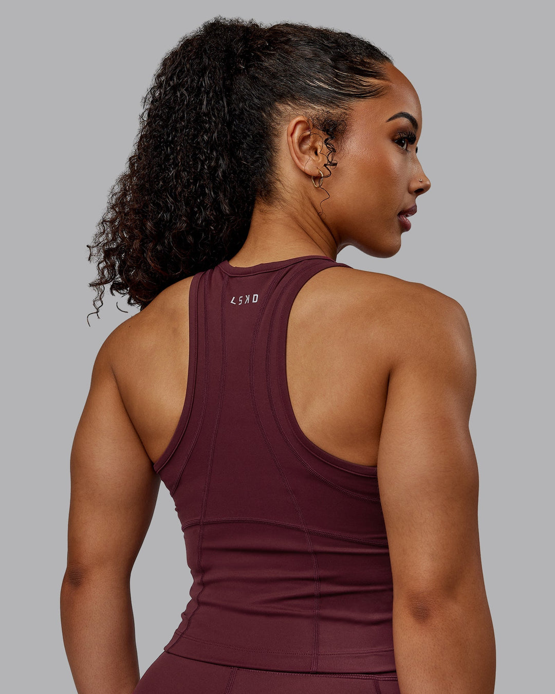 Woman wearing Bend Performance Tank - Dark Cherry