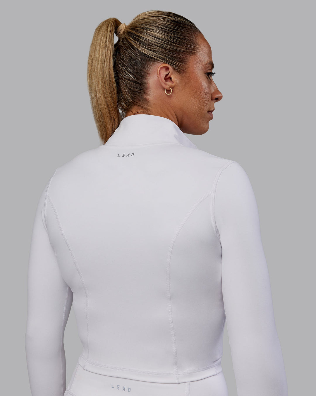 Woman wearing Bree Masters Stride Zip Through Cropped Jacket - White