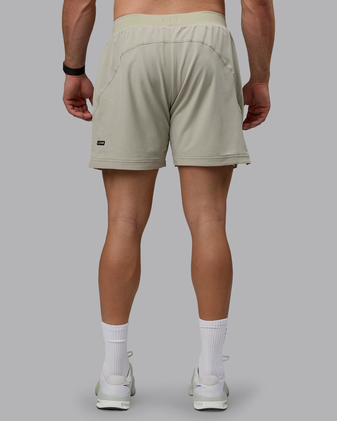 Man wearing Challenger 6&quot; Lined Performance Shorts - Sustained Grey