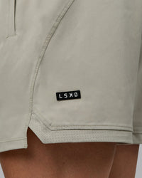 Man wearing Challenger 6" Performance Shorts - Sustained Grey