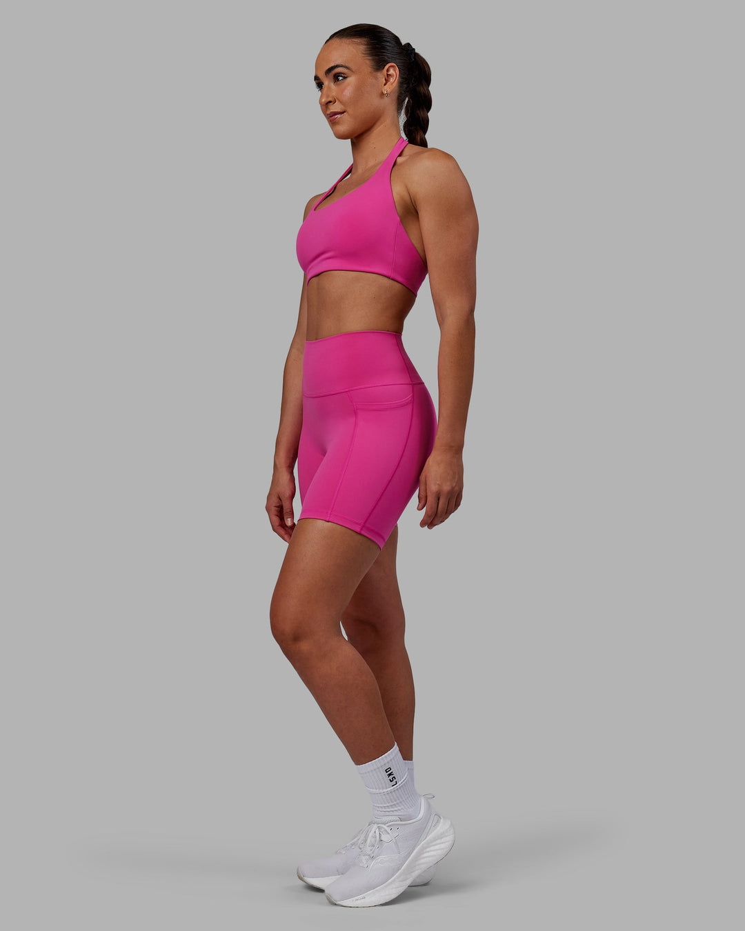 Woman wearing Challenger Sports Bra - Fuchsia Pink