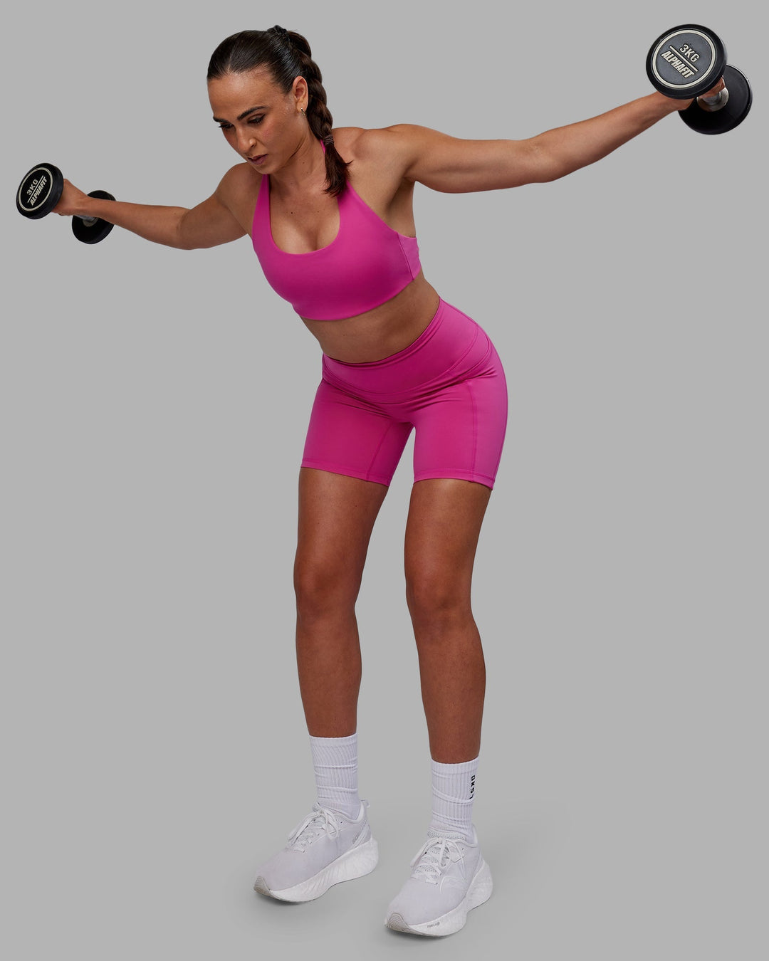 Woman wearing Challenger Sports Bra - Fuchsia Pink