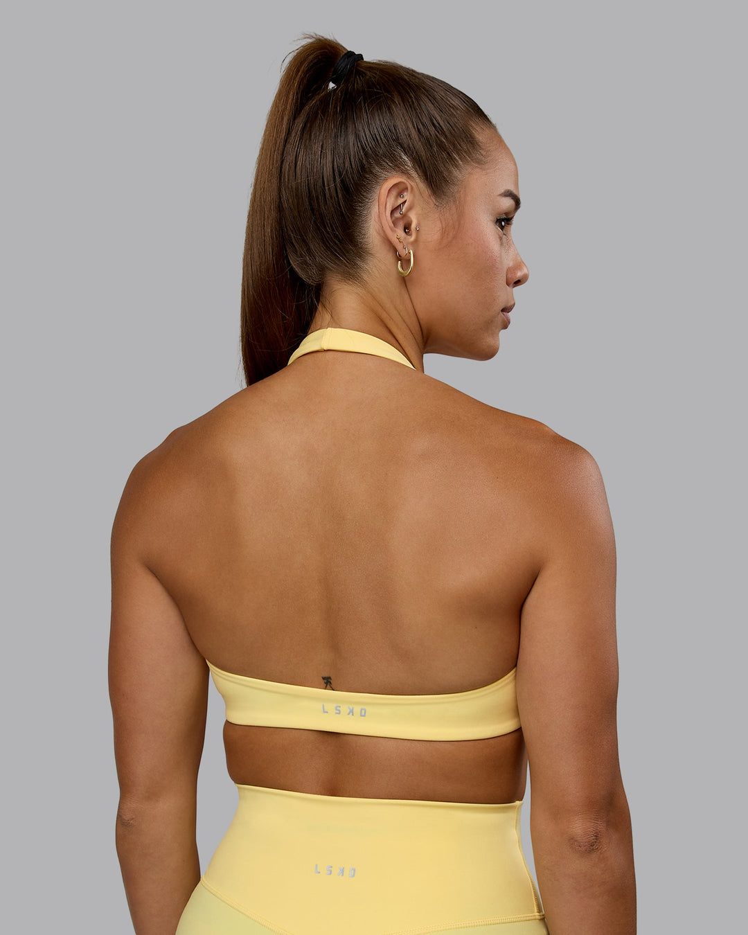 Woman wearing Challenger Sports Bra - Lemon