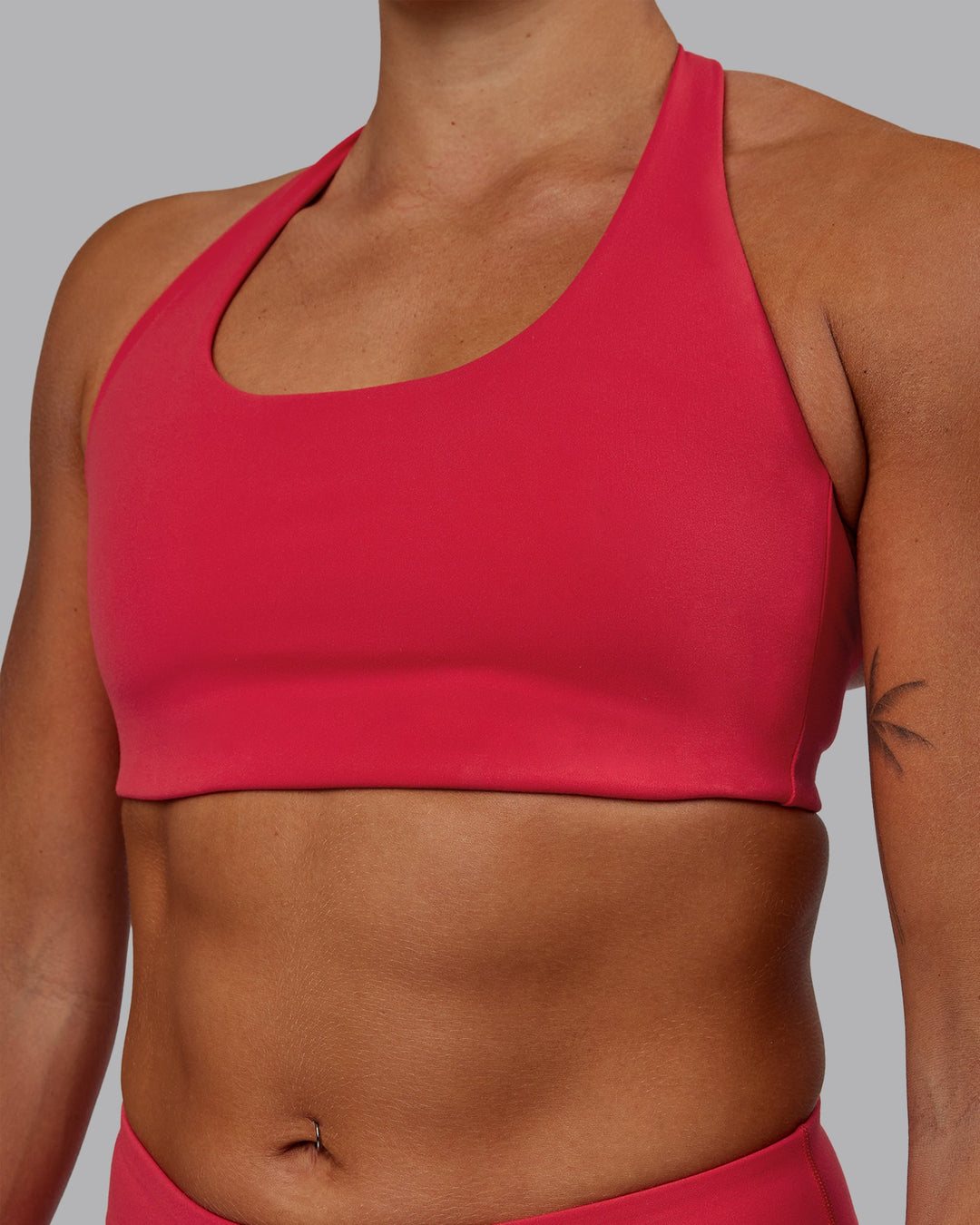 Woman wearing Challenger Sports Bra - Scarlet