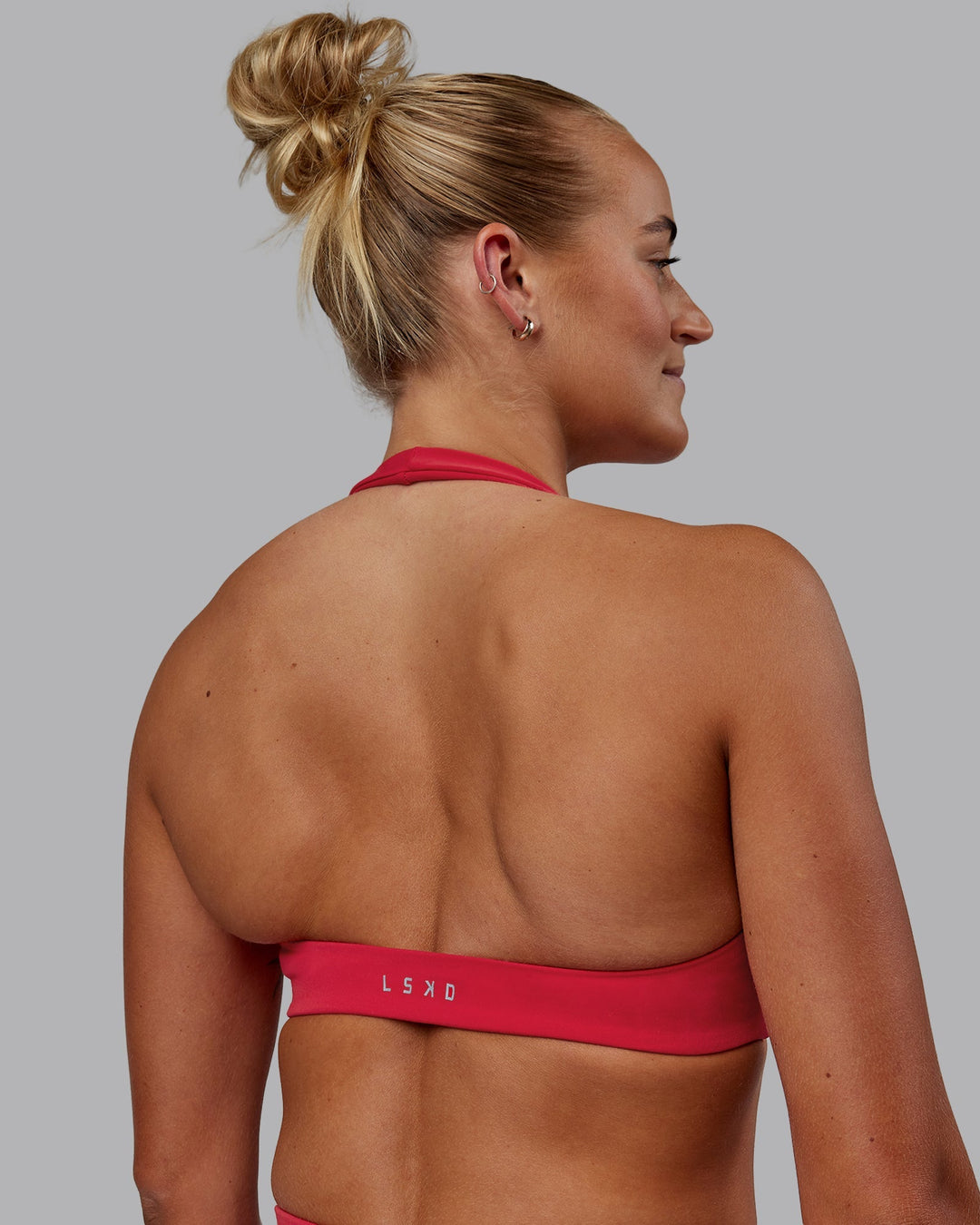 Woman wearing Challenger Sports Bra - Scarlet