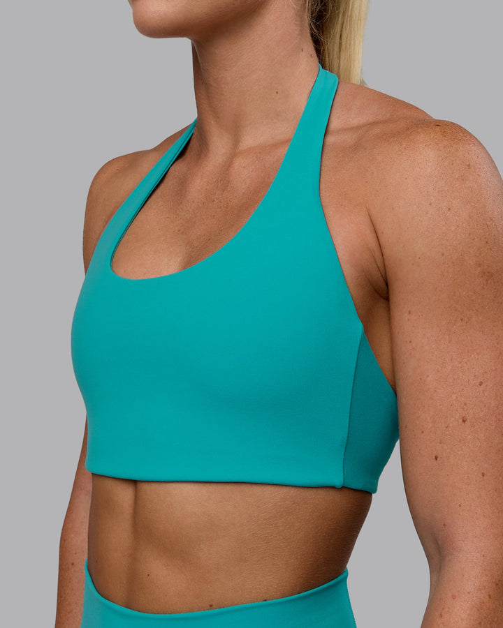 Woman wearing Challenger Sports Bra - Uplift Blue
