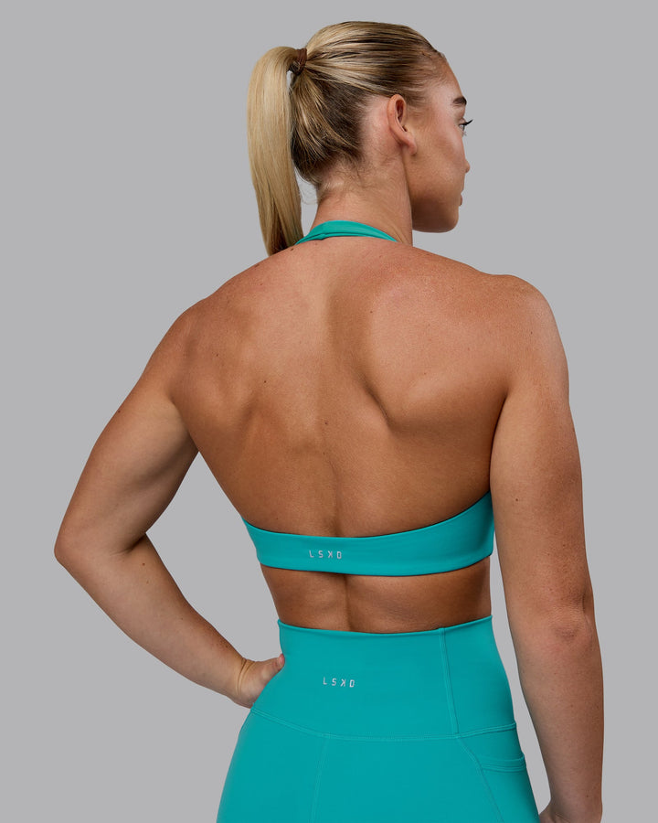 Woman wearing Challenger Sports Bra - Uplift Blue
