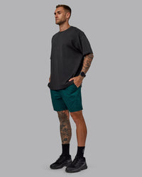 Man wearing Daily 7" Shorts - Dark Moss