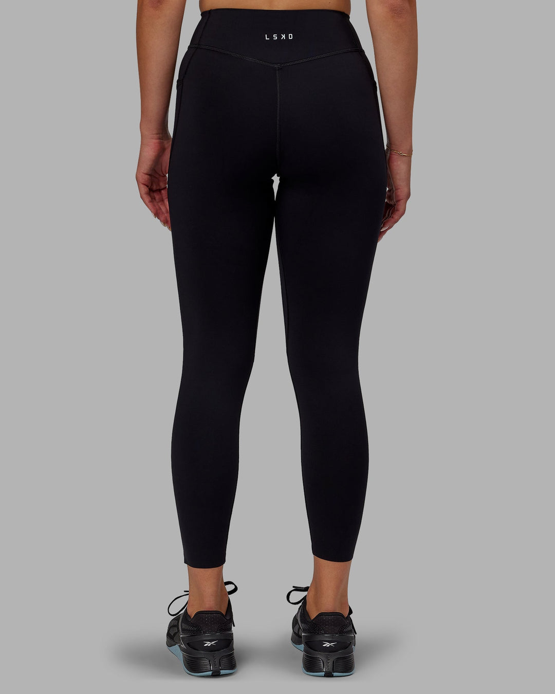 Woman wearing Elite 7/8 Length Leggings - Black