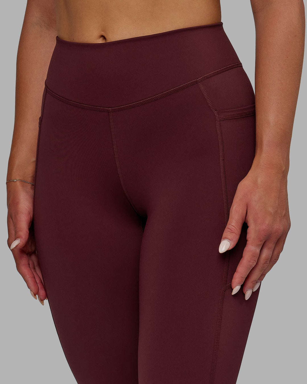 Woman wearing Elite 7/8 Length Leggings - Dark Cherry