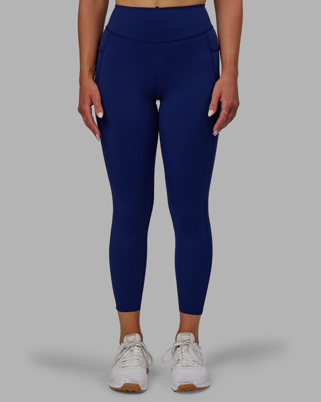 Woman wearing Elite 7/8 Length Leggings - Midnight Blue