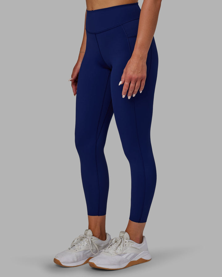 Woman wearing Elite 7/8 Length Leggings - Midnight Blue
