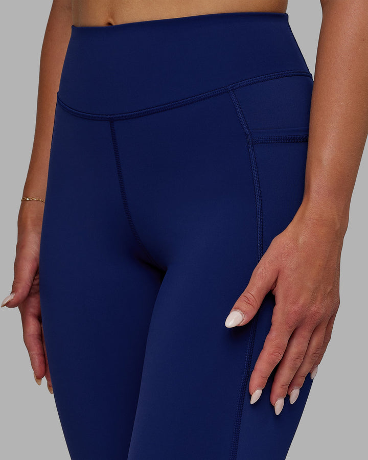 Woman wearing Elite 7/8 Length Leggings - Midnight Blue
