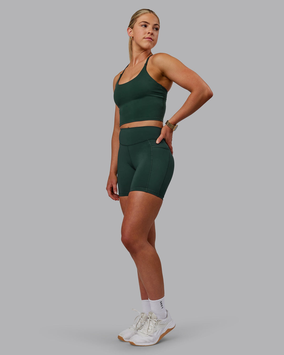 Woman wearing Elite Mid-Length Shorts - Vital Green