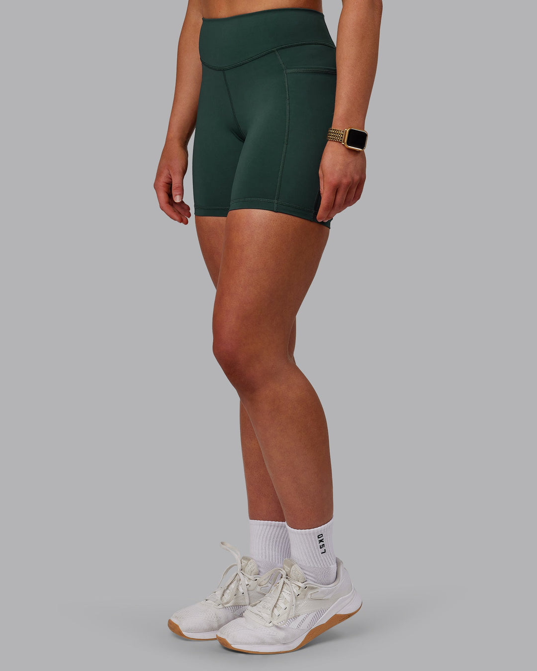 Woman wearing Elite Mid-Length Shorts - Vital Green