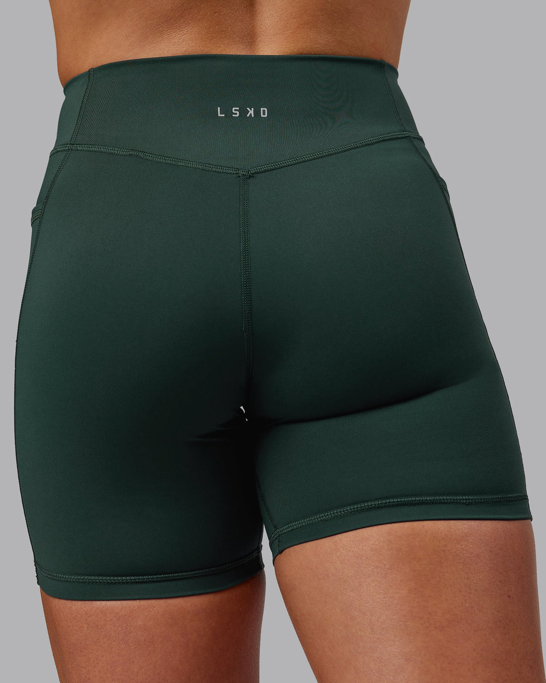 Woman wearing Elite Mid-Length Shorts - Vital Green