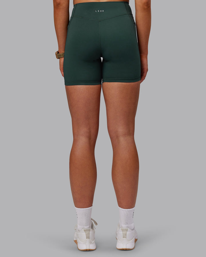 Woman wearing Elite Mid-Length Shorts - Vital Green
