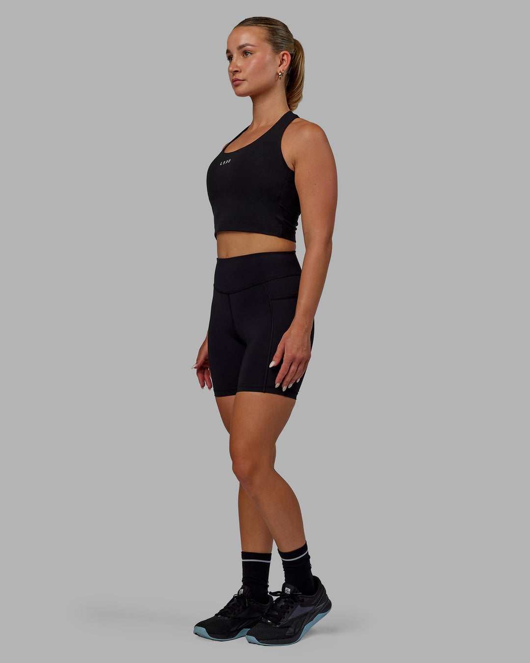 Woman wearing Elite Mid-Length Shorts - Black