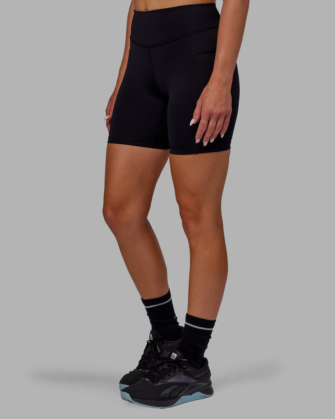 Woman wearing Elite Mid-Length Shorts - Black