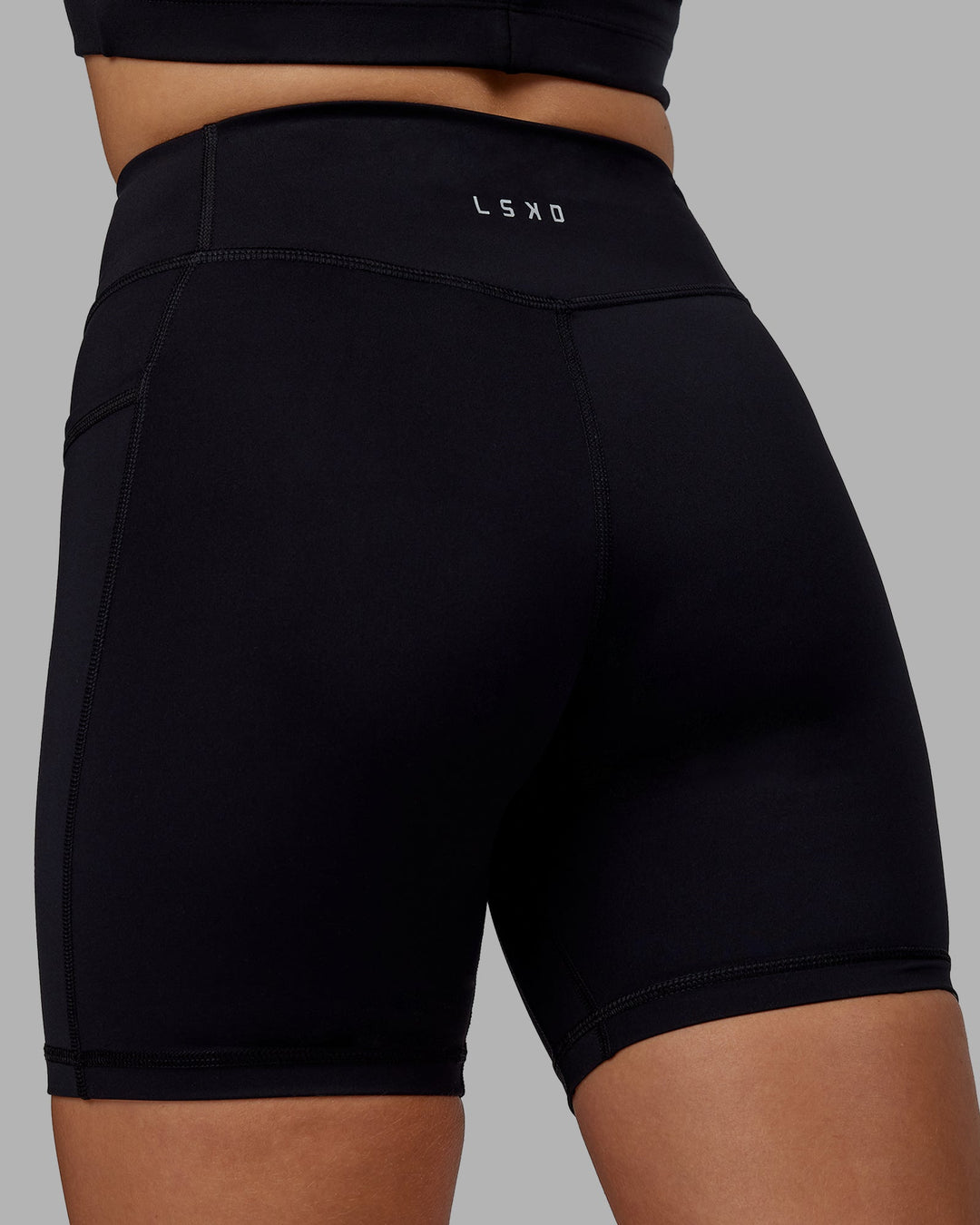 Woman wearing Elite Mid-Length Shorts - Black