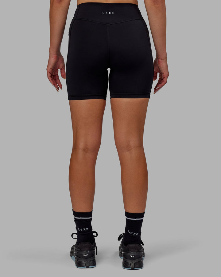 Woman wearing Elite Mid-Length Shorts - Black
