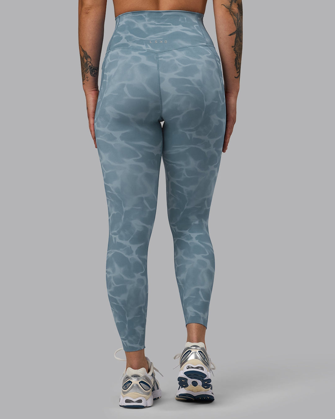 Woman wearing Elixir 7/8 Length Leggings With Pockets - Tranquil-Elemental Blue