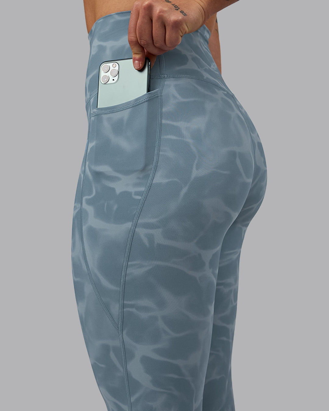 Woman wearing Elixir 7/8 Length Leggings With Pockets - Tranquil-Elemental Blue