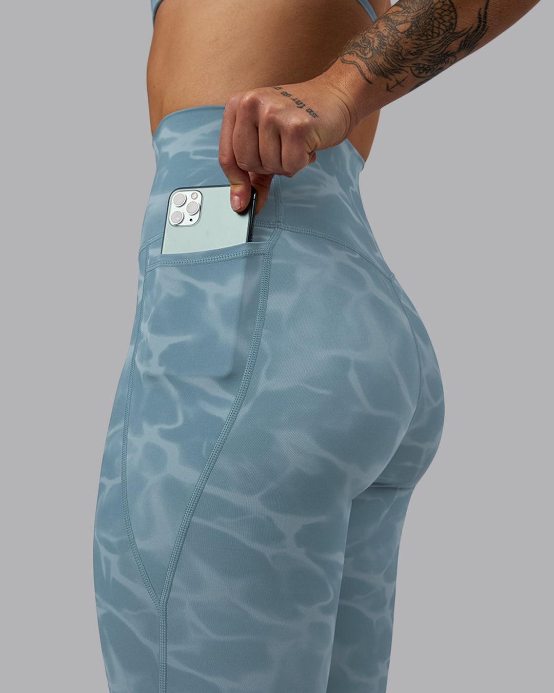 Woman wearing Elixir Full Length Leggings With Pockets - Tranquil-Elemental Blue