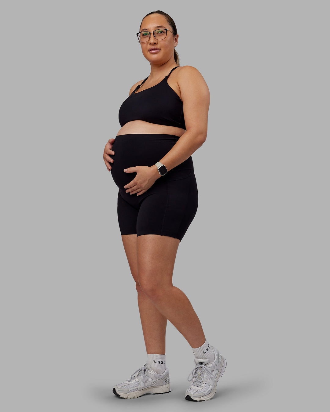 Woman wearing Elixir Maternity Mid Short Tights With Pockets - Black