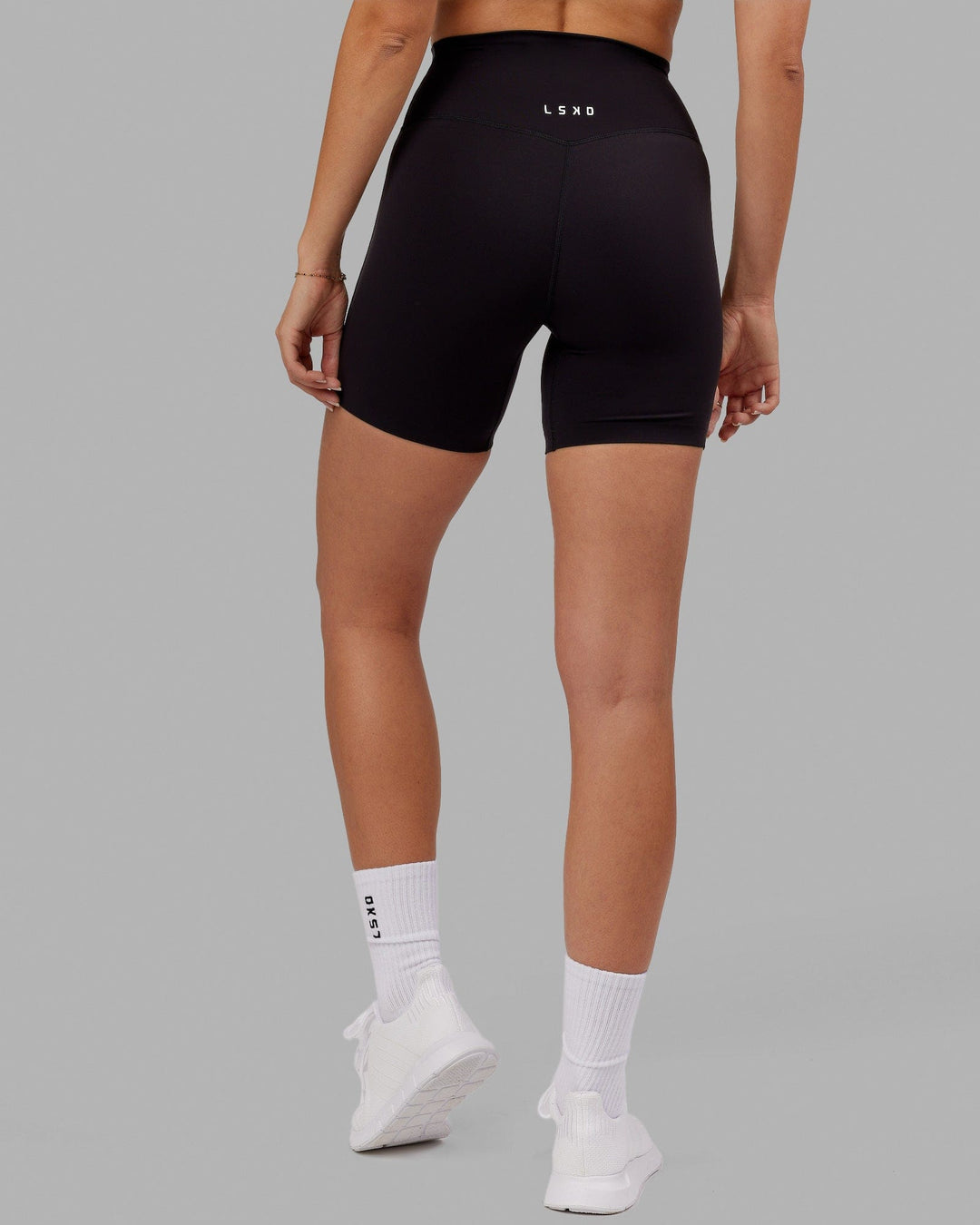 Woman wearing Elixir Mid Short Tight - Black No Logo