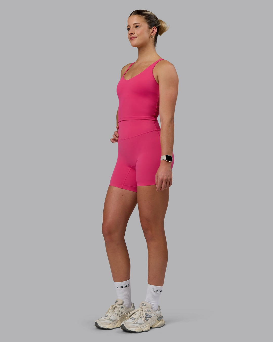 Woman wearing Elixir Mid Short Tights - Pink Flash