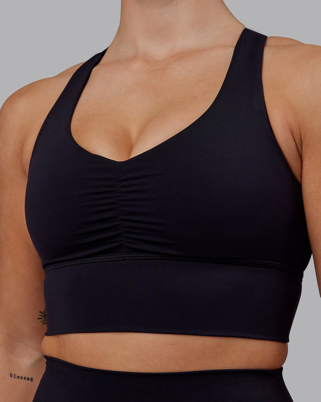 Woman wearing Evoke Sports Bra - Black