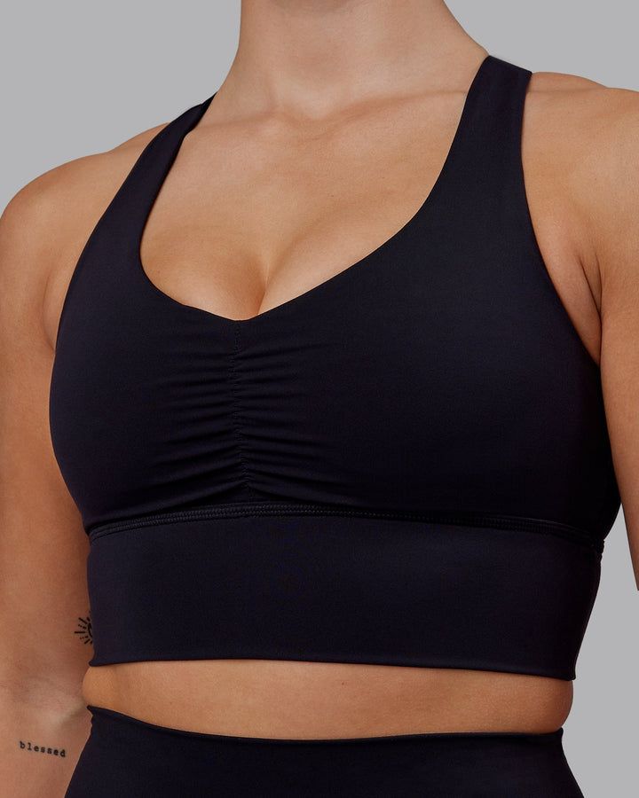 Woman wearing Evoke Sports Bra - Black
