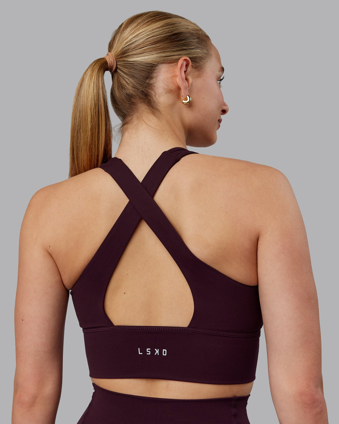 Woman wearing Evoke Sports Bra - Mulberry