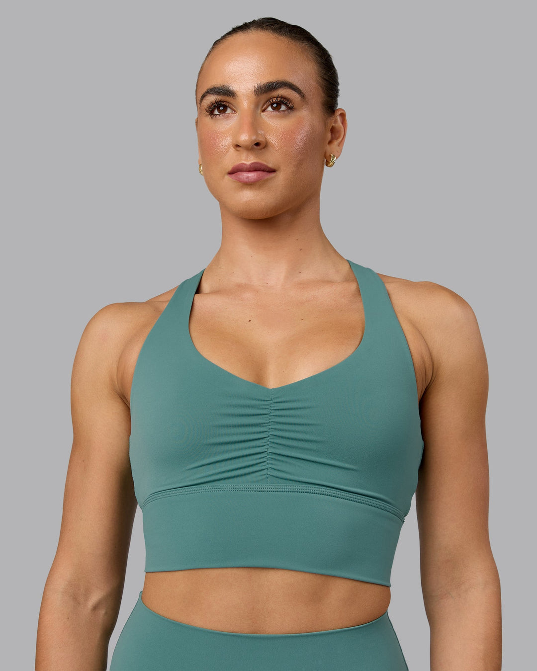 Woman wearing Evoke Sports Bra - Sagebrush