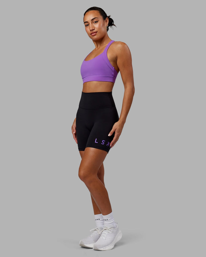 Woman wearing Evolved Mid-Length Shorts - Black-Purple Swirl
