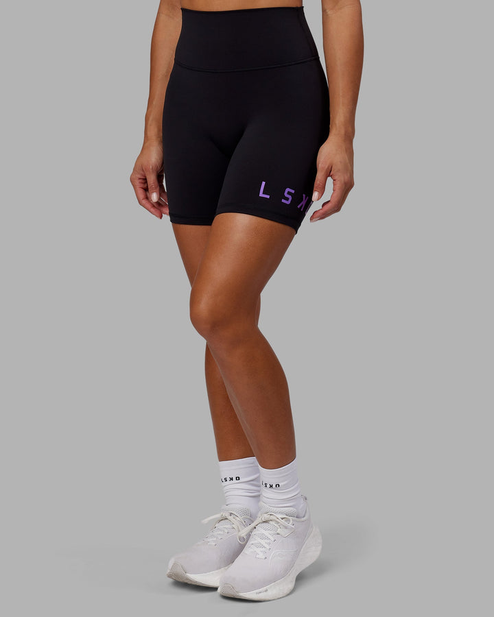 Woman wearing Evolved Mid-Length Shorts - Black-Purple Swirl
