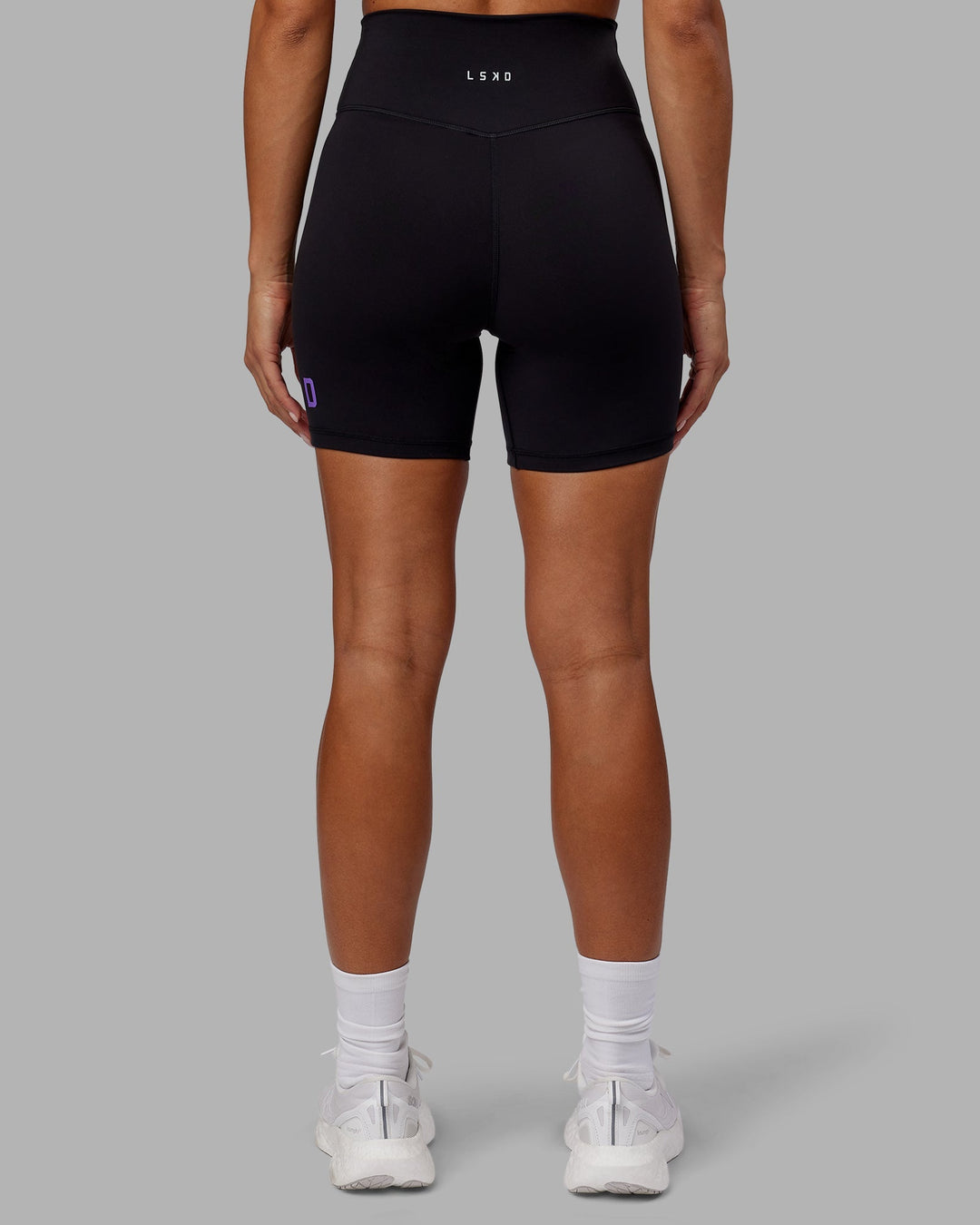 Woman wearing Evolved Mid-Length Shorts - Black-Purple Swirl