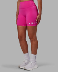 Woman wearing Evolved Ultra High-Rise 6" Short - Fuchsia Pink-White